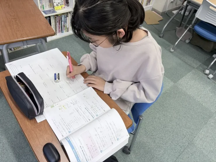ワークを開き、シャープペンで書き込む在校生の手元