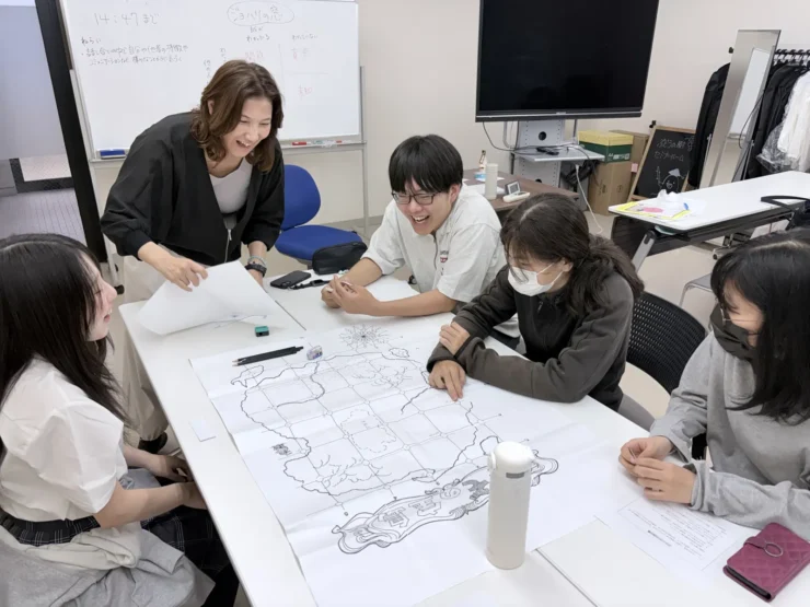 地図を使ったグループワークで、スクールカウンセラーと生徒たちが声をあげて笑い合う様子
